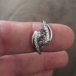New silver ring with three purplish colored stones